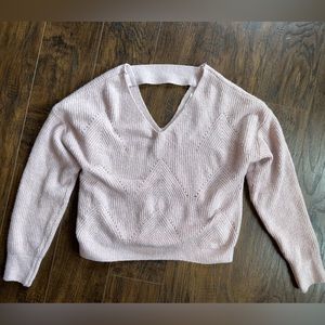 Slightly cropped sweater. V cut in front and back. Never worn